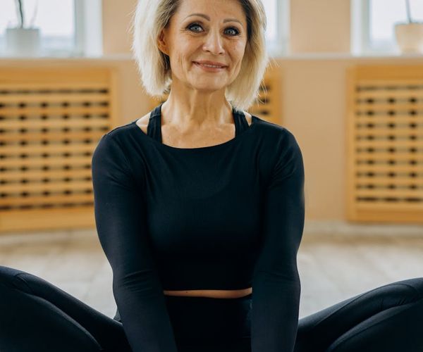 A smiling person looking serene and strong after a yoga session.